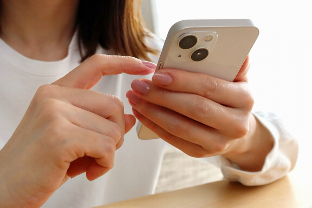 スマートフォンで予約やお問い合わせをする女性の手元|松村有花メソッドスクール